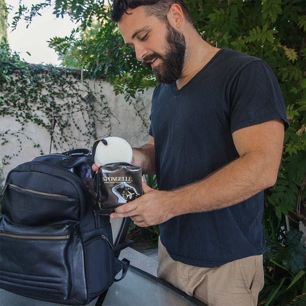 Angled front view with bag zipped and handles upright.